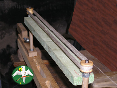 When doing strings with high numbers of strands the jig needs to be of very sturdy construction or to be stiffened by something adaquate. Otherwise it will deform under the cummulated pressure of every added strand. My rather crued but versatile jig serves me well since over 20 years now. For doing crossbow strings I simply insert a board, cut to propper lenght, to insure it stays in form.   © Falk 2007